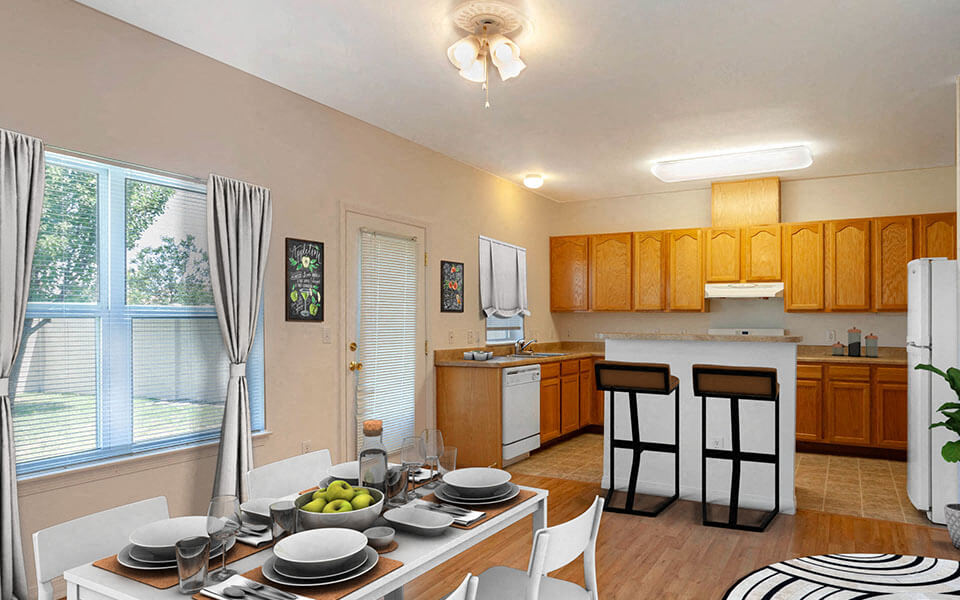a kitchen and dining room with a table and chairs