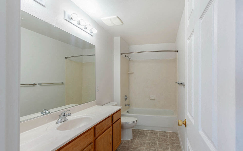 a bathroom with a sink toilet and a mirror