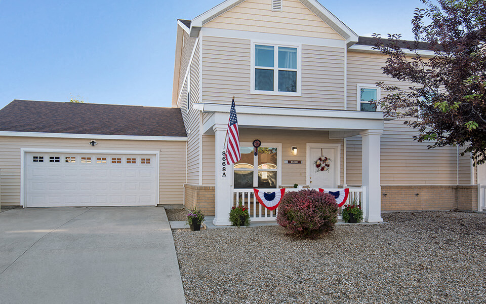 a home with an flag on the front porch