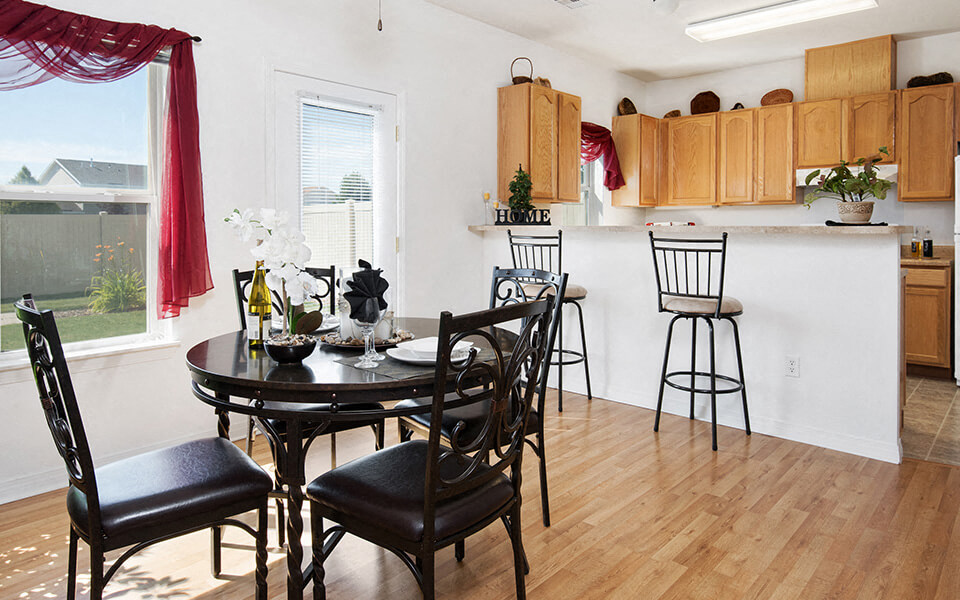 a kitchen and dining room with a table and chairs