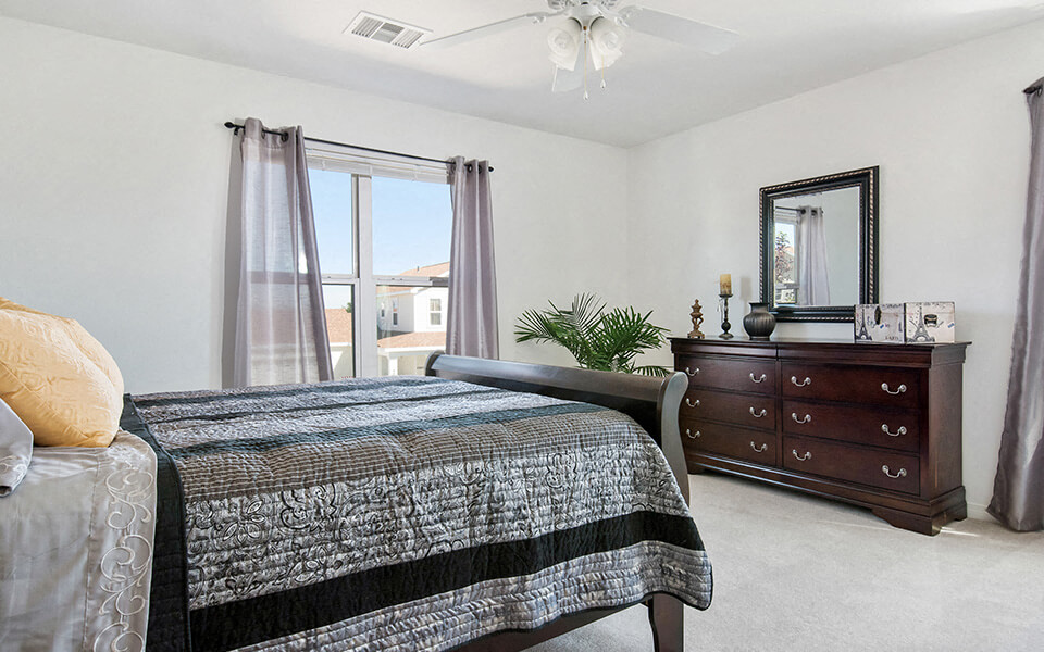 a bedroom with a bed and a dresser