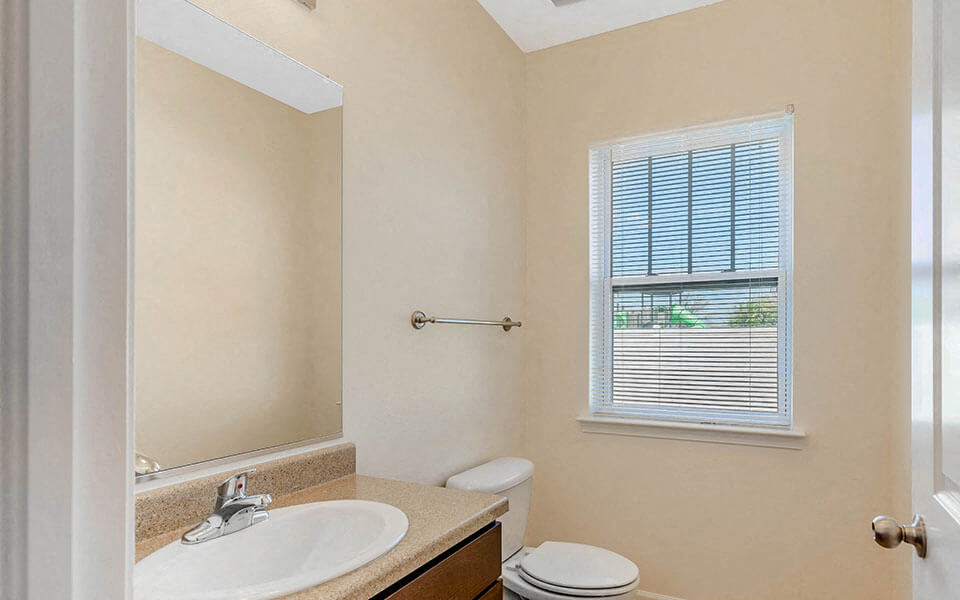 a bathroom with a sink toilet and a mirror