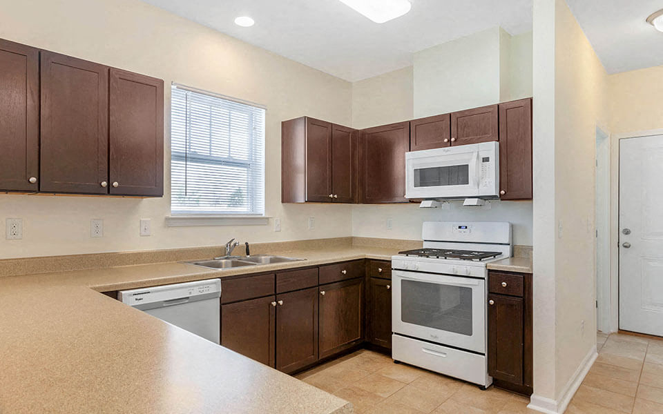 a kitchen with a stove microwave and a sink