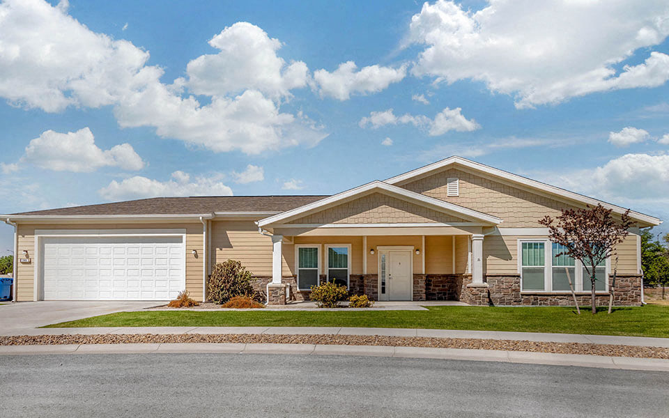 a beige house with a garage door