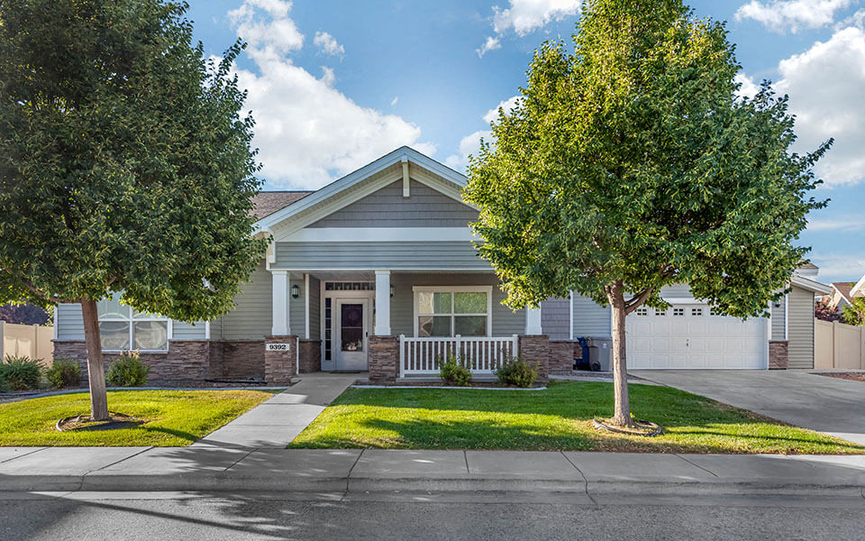 a house with two trees in front of it