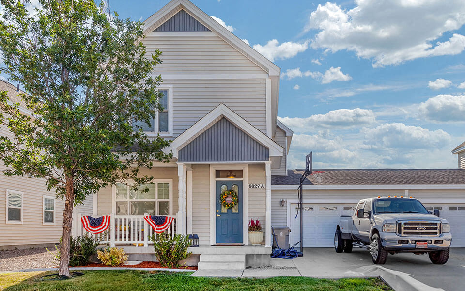 a white house with a truck parked in front of it