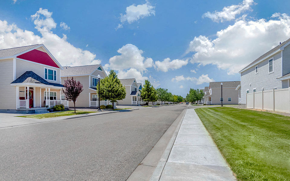 an empty street with houses on both sides of it