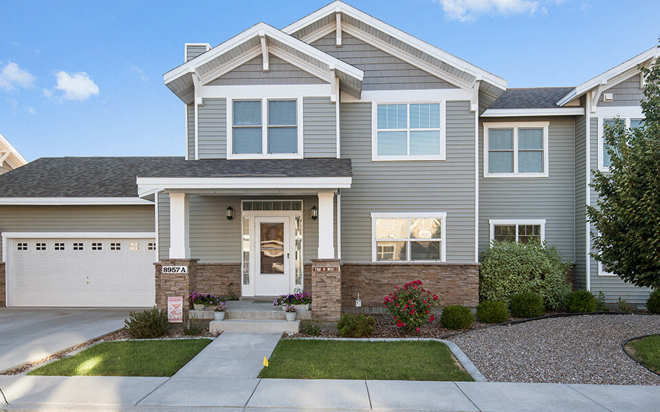 a gray house with a white garage door