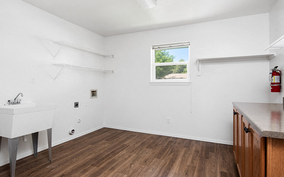 an empty room with a sink and a window