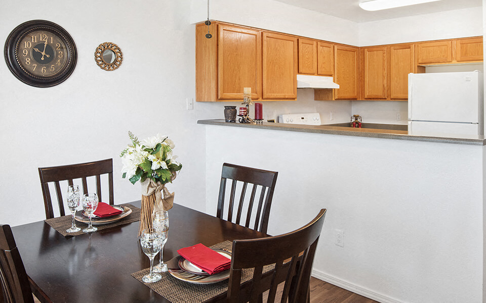 a dining room with a table and chairs and a kitchen