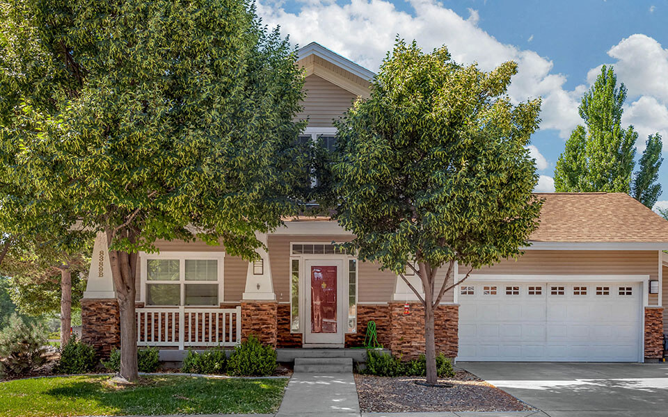 a house with two trees in front of it