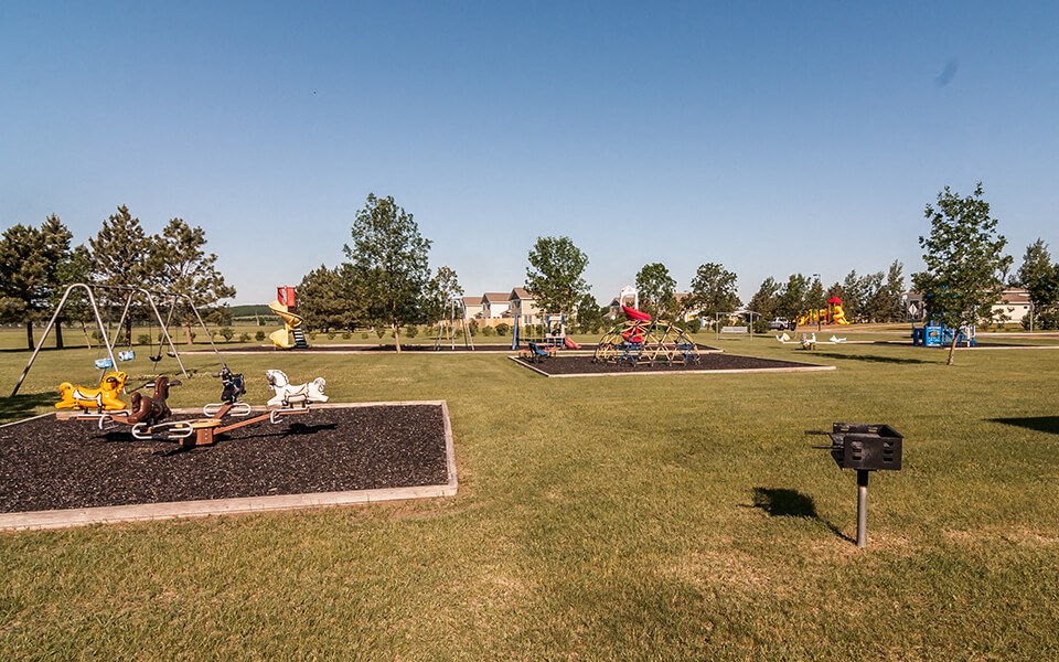 a park with a playground and childrens playground equipment