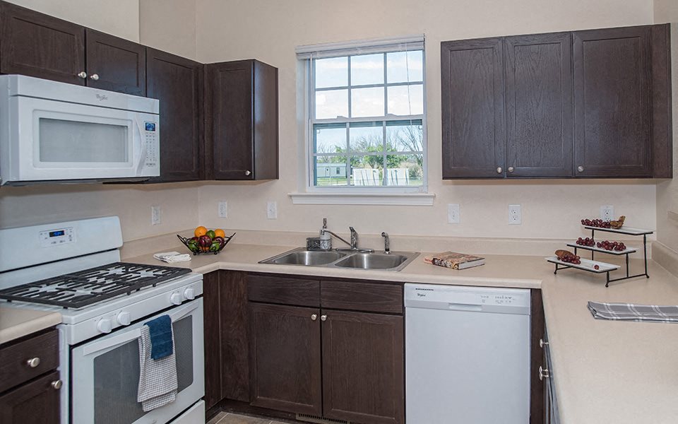 a kitchen with a stove microwave and sink