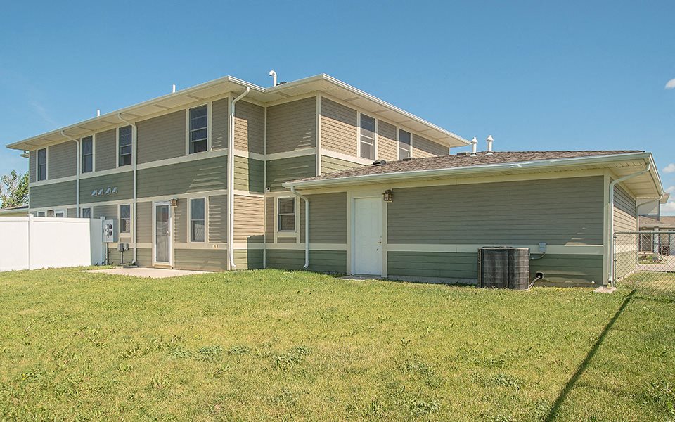 a house with a grass yard in front of it