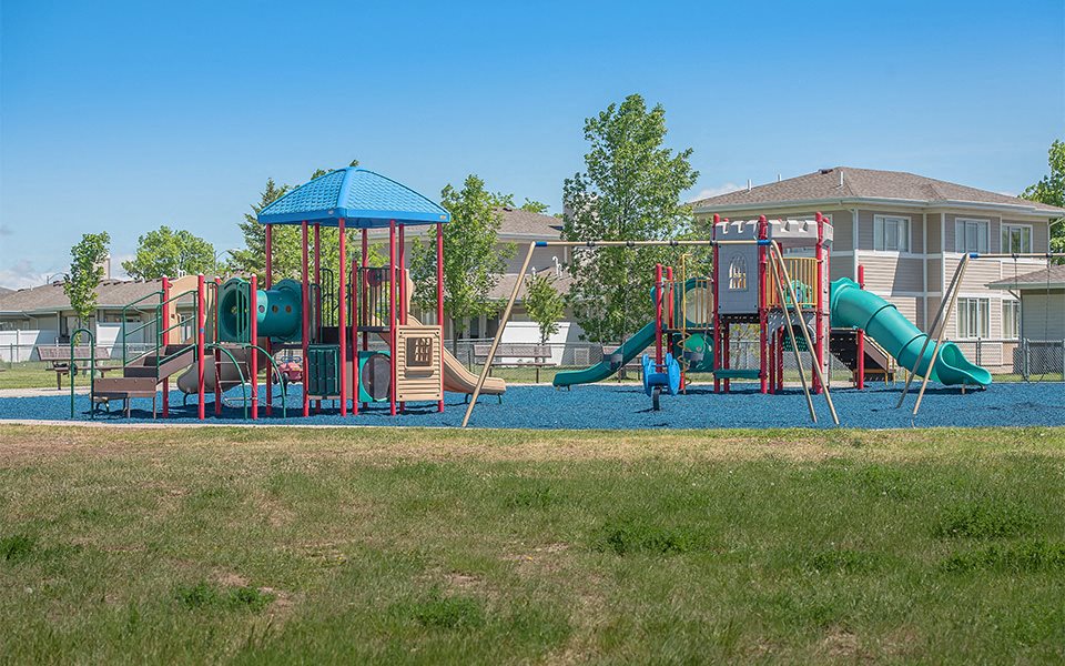 a playground with a swing set and other playground equipment