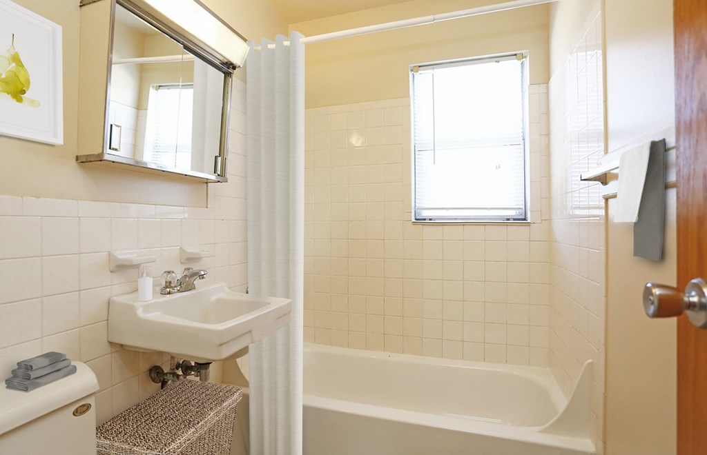 a bathroom with a sink and a tub and a shower curtain