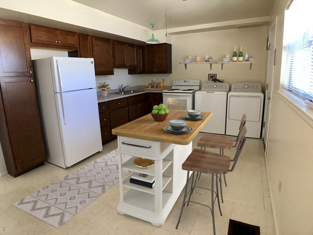 a kitchen with white appliances and a wooden table with two chairs