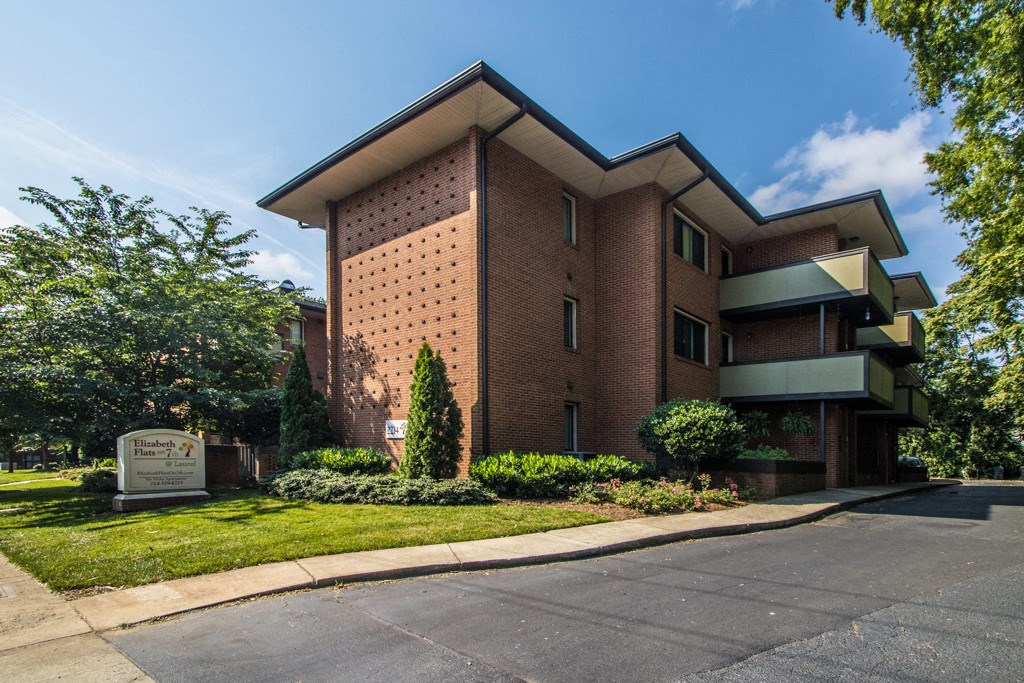 a large brick building with a sign in front of it