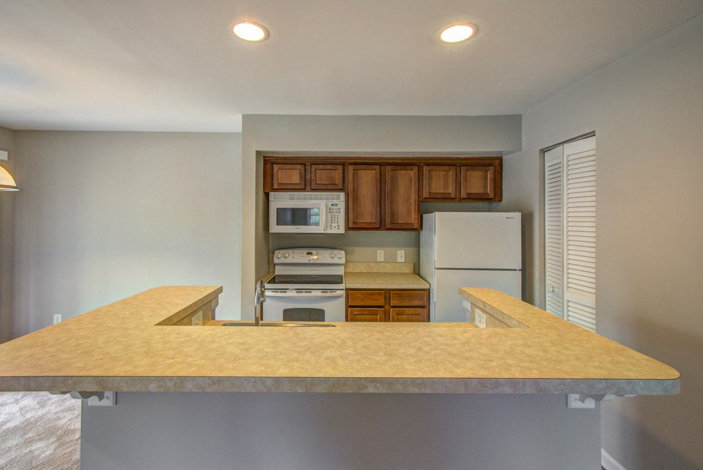 a kitchen with a counter top and a refrigerator