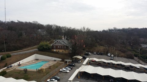 a view of a pool and a building from a roof
