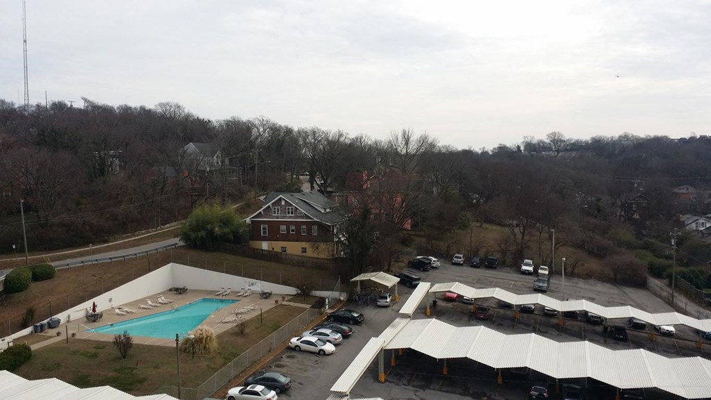 a view of a pool and a building from a roof