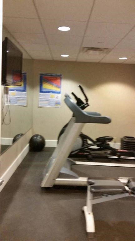 a gym with a treadmill and weights in it