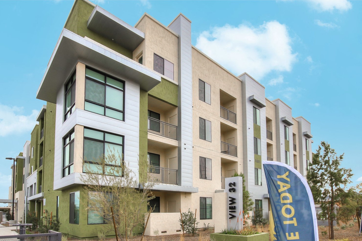 A modern building with the name "YAGOT 3" on a banner in front.