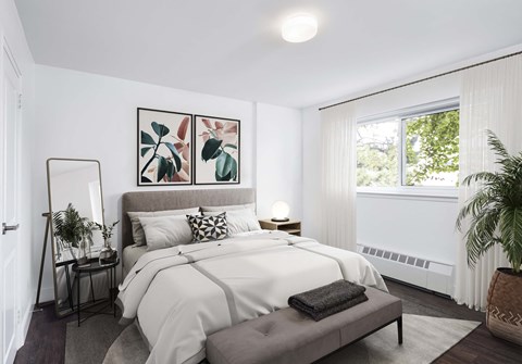 Bedroom staged with a bed and artwork