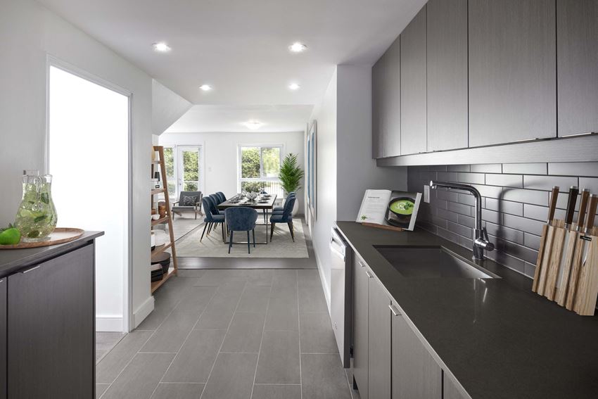 Kitchen overlooking a staged dining room and living room