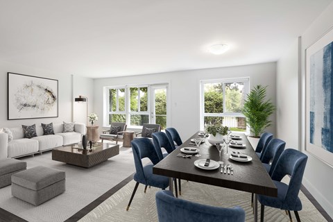 a living room with a large wooden table and blue chairs