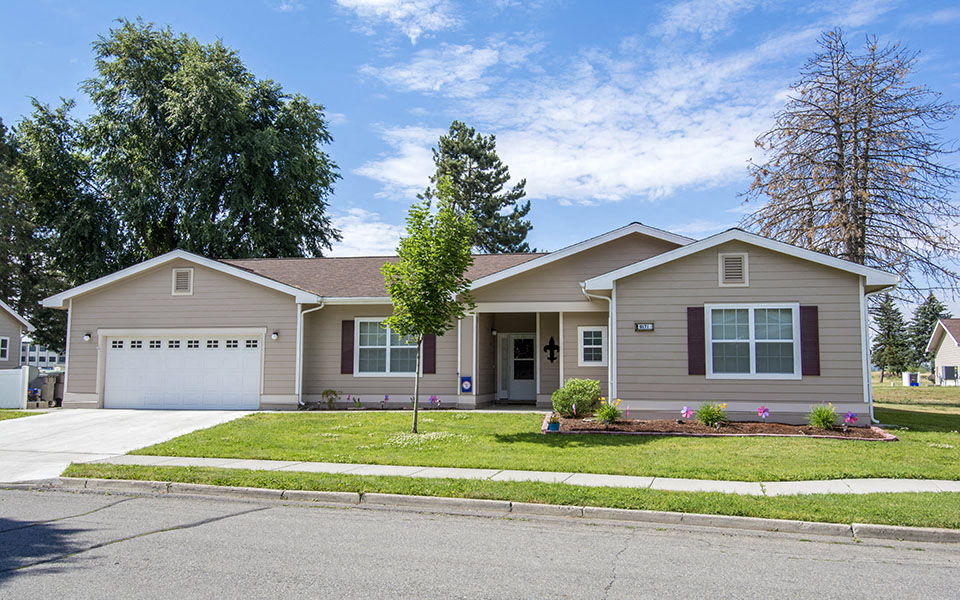 a beige house with a white garage door