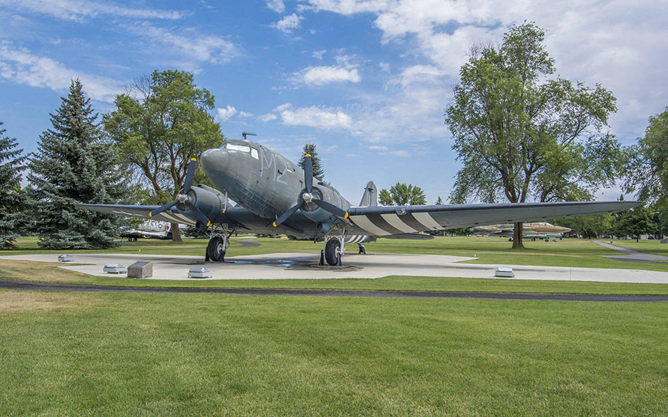 an airplane sitting on a runway in a park