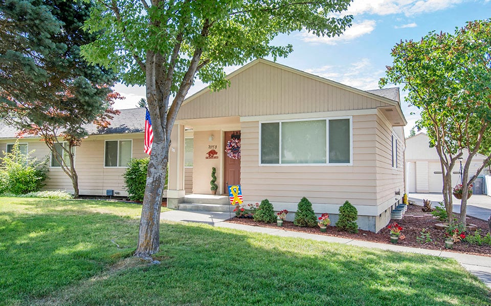 a house with an flag in the front yard