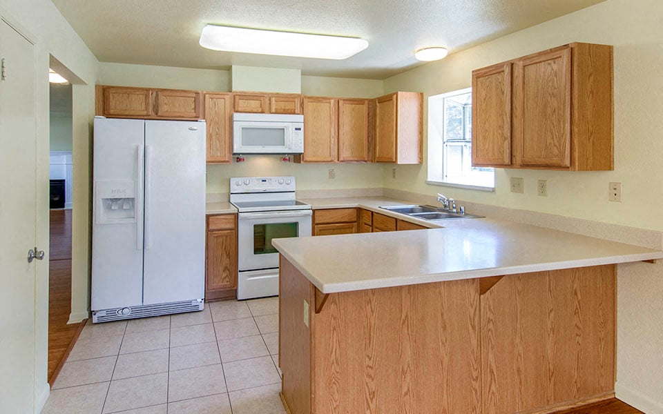 a kitchen with a stove refrigerator and a sink