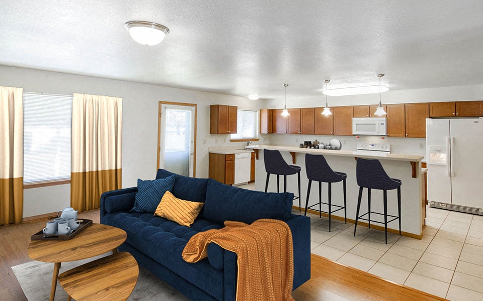 a living room and kitchen with a blue couch