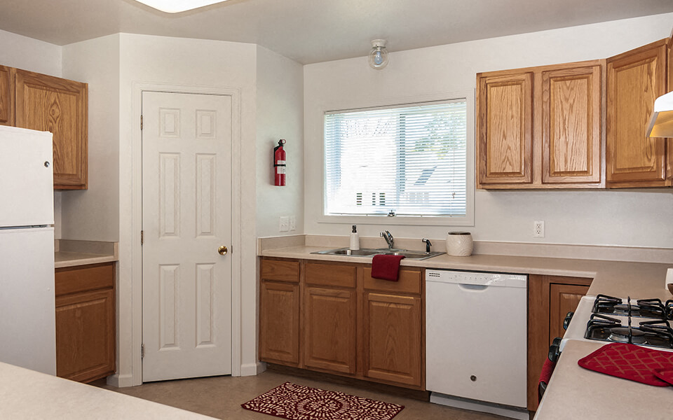 a kitchen with wooden cabinets and a white refrigerator