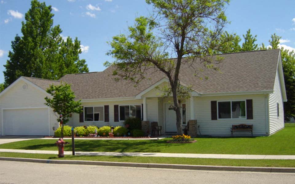 a white house with a fire hydrant in front of it