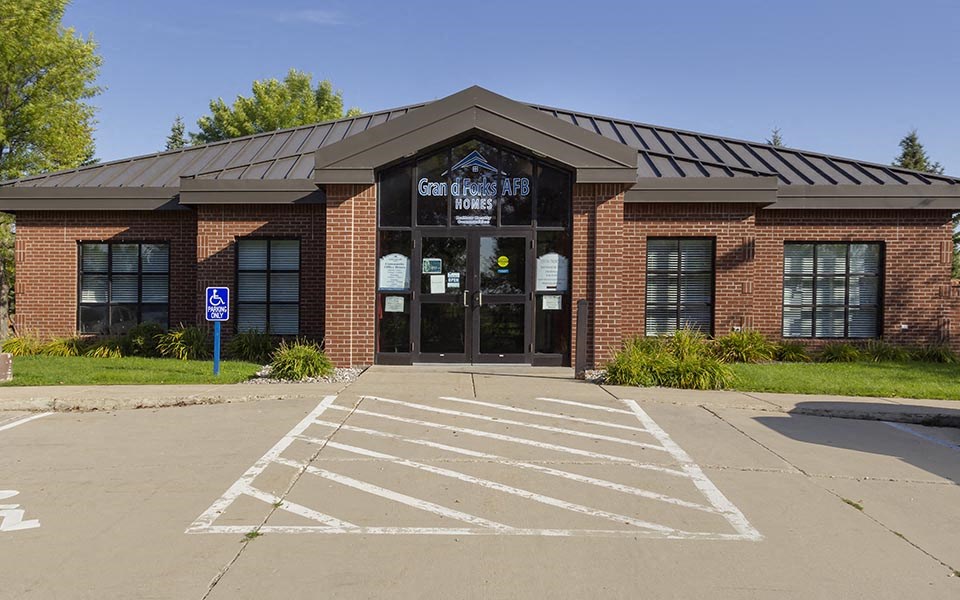 an empty parking lot in front of a brick building