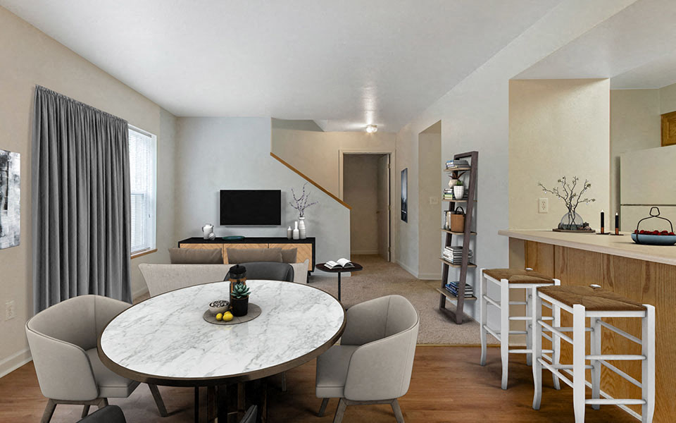 a living room and dining room with a table and chairs