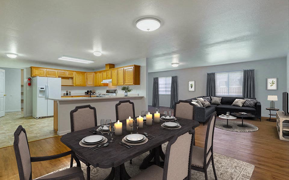 a living room with a dining room table with candles