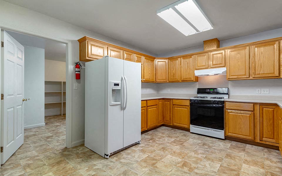 a kitchen with wooden cabinets and a white refrigerator