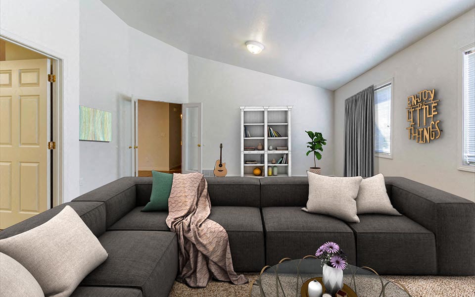 a living room with a gray couch and a table