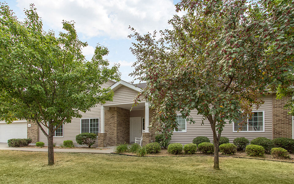 a house with two trees in front of it
