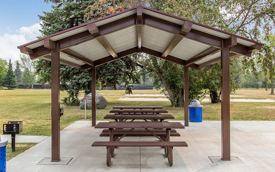 a picnic table under a pavilion in a park
