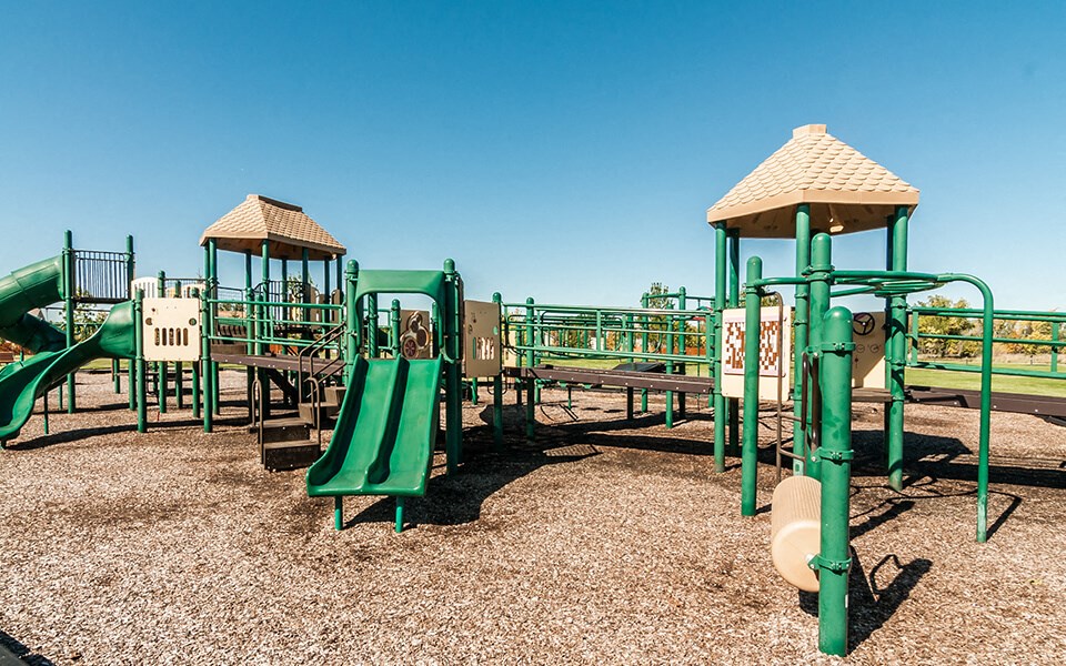 a playground with slides and structures on a sunny day