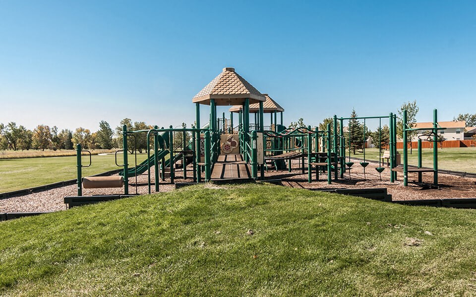 a playground at a park with a gazebo