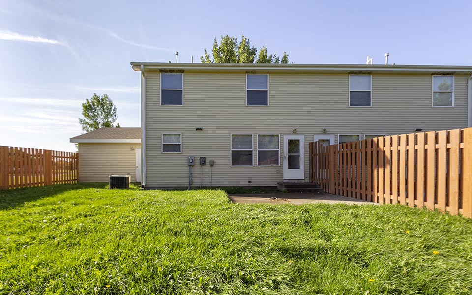 a house with a yard and a fence