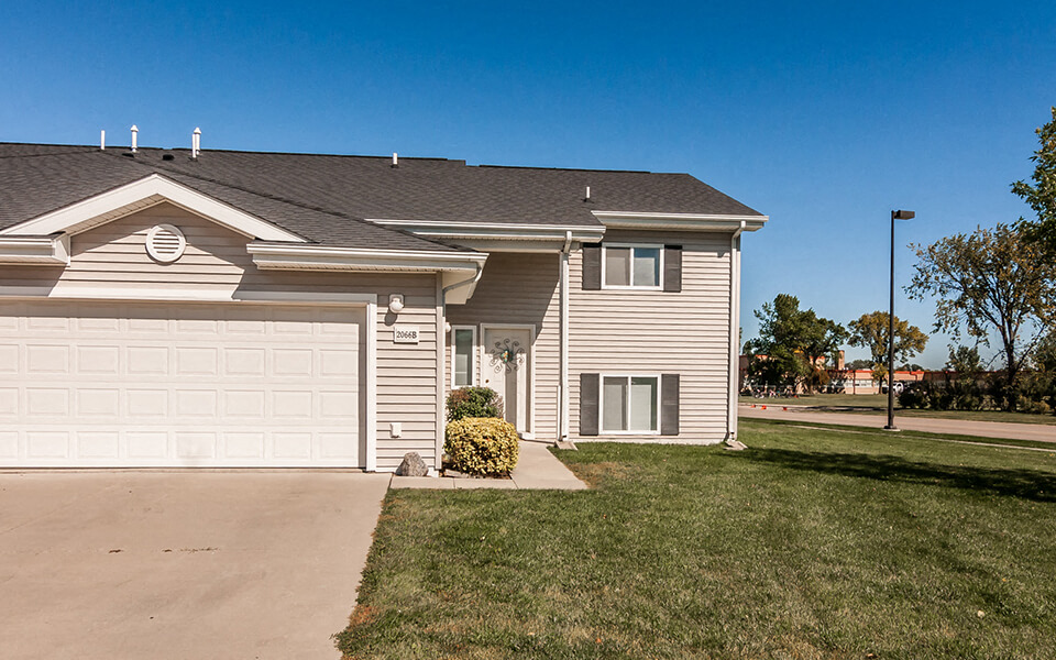 a house with a white garage door and a lawn