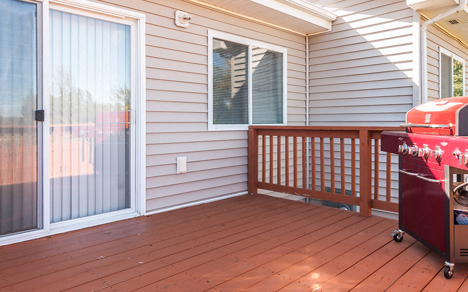 the deck is equipped with a grill and a patio