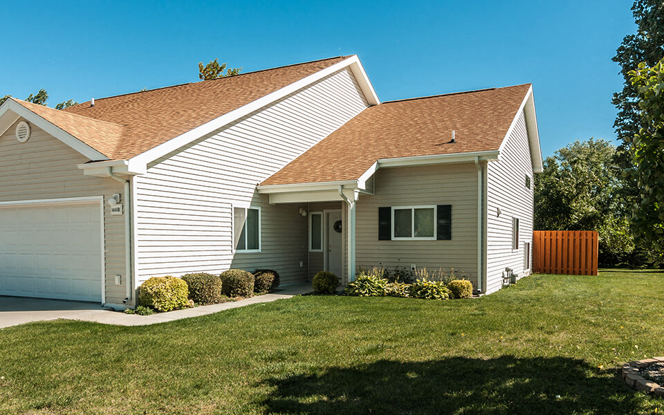 a white house with a lawn in front of it